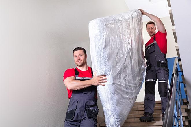 heavy lifting as box spring is transported out of a building in Bethesda OH